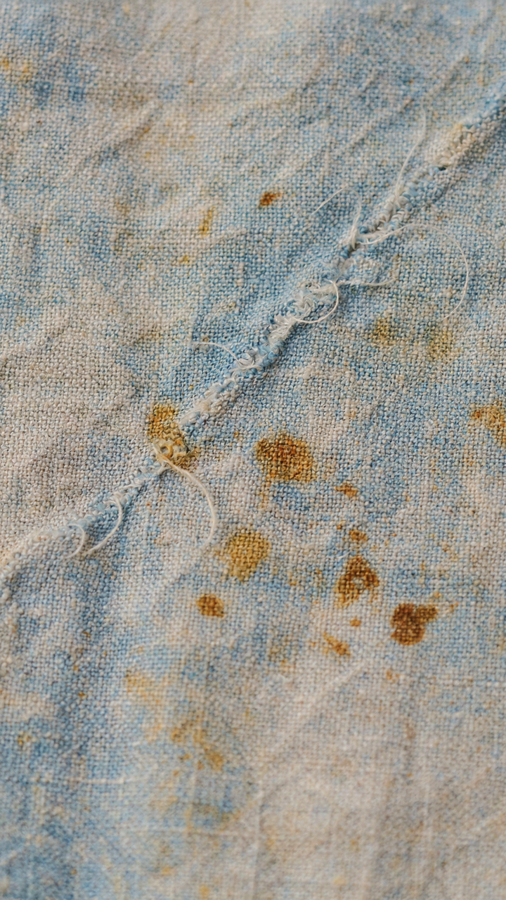 Sun-damaged, faded fabric shows visible cracks and discoloration from UV exposure.
