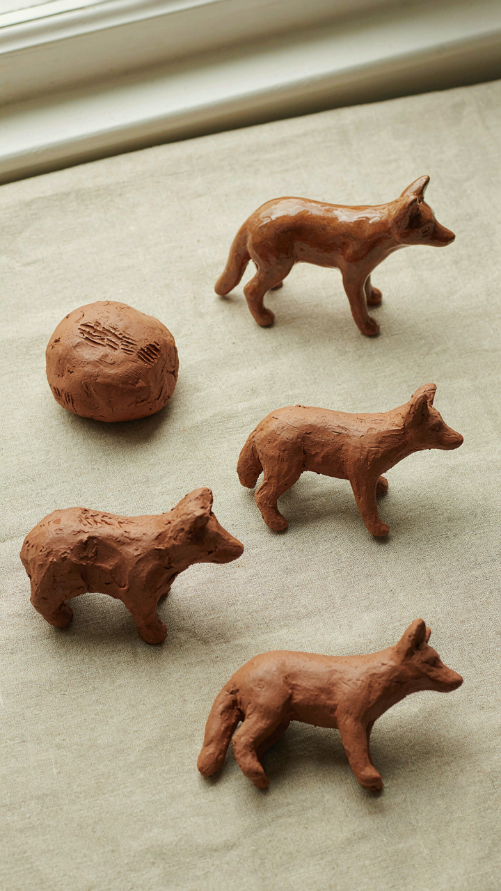 Several clay sculptures of an animal, from simple to detailed.