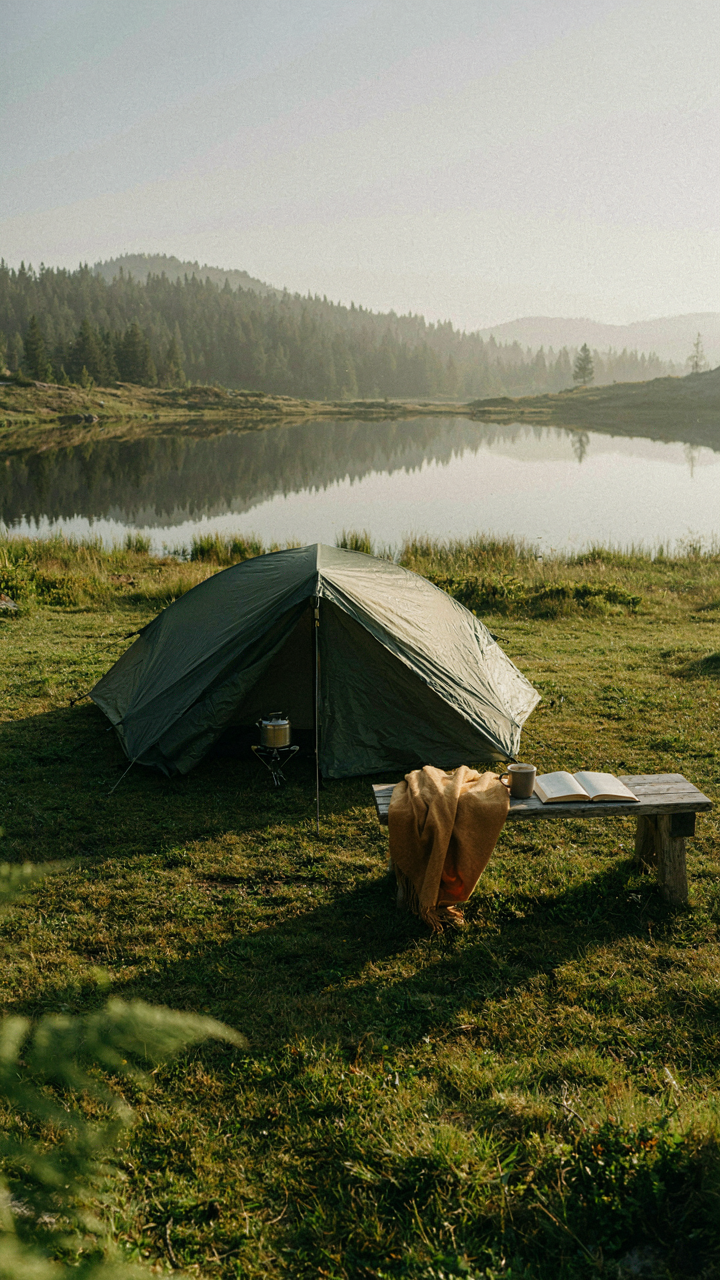 A minimalist camping setup shows essential gear neatly arranged outdoors.