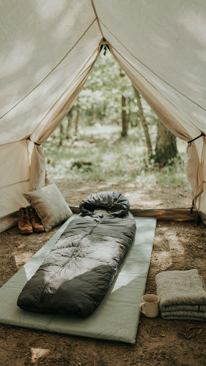 A simple tent bed setup includes just a sleeping pad, bag, and pillow.