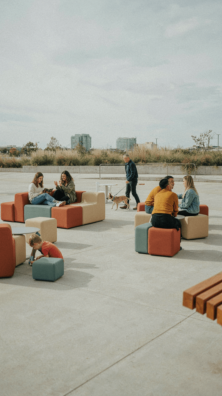 People use modular seating in a public plaza.