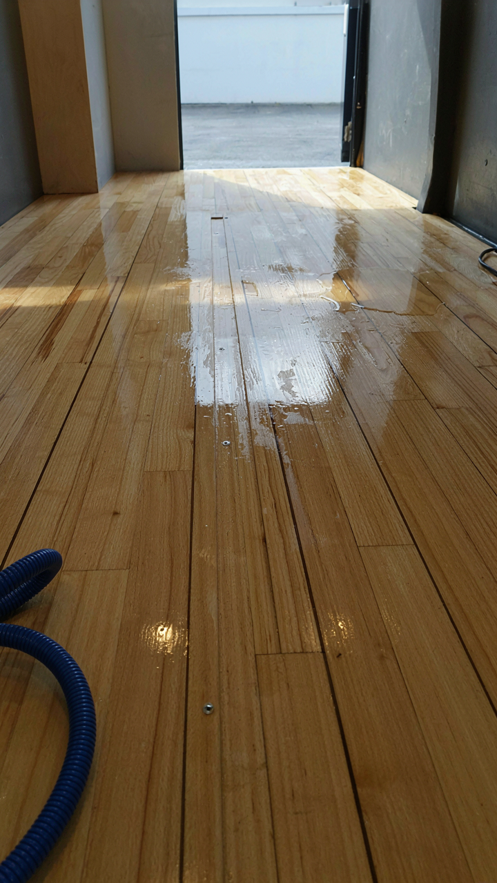 A wide shot of a pristine, newly installed camper floor.