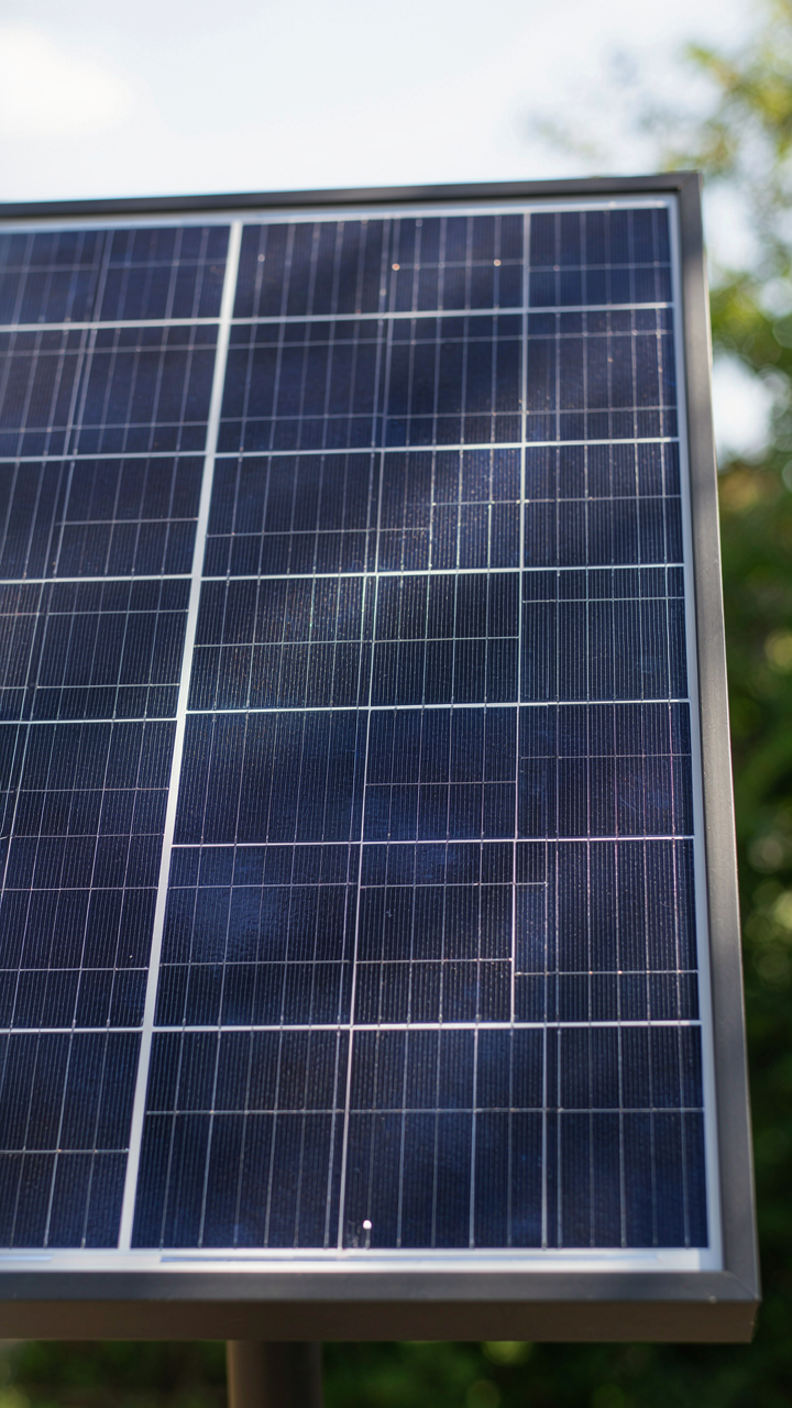 A close up shows sunlight hitting a solar panel on a lantern.