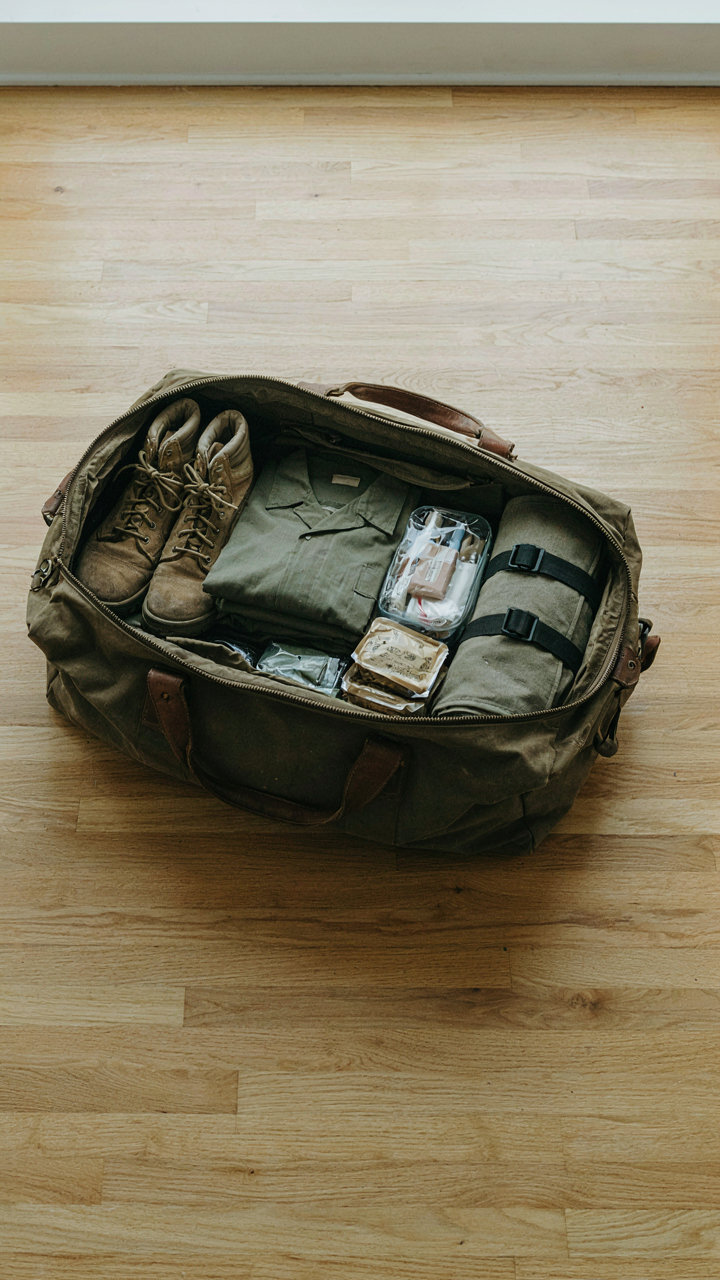 A military bag is open, showing items packed in a very neat way.