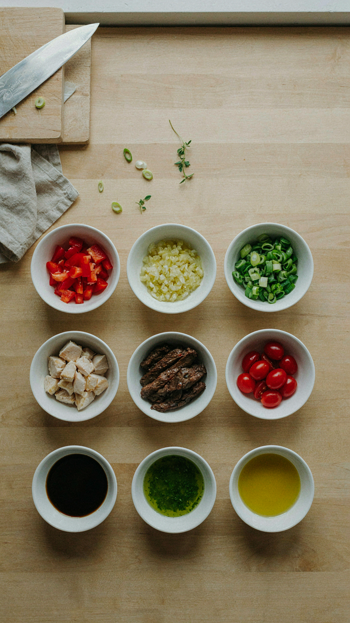 A chef's mise en place with neatly prepped ingredients on a kitchen counter.