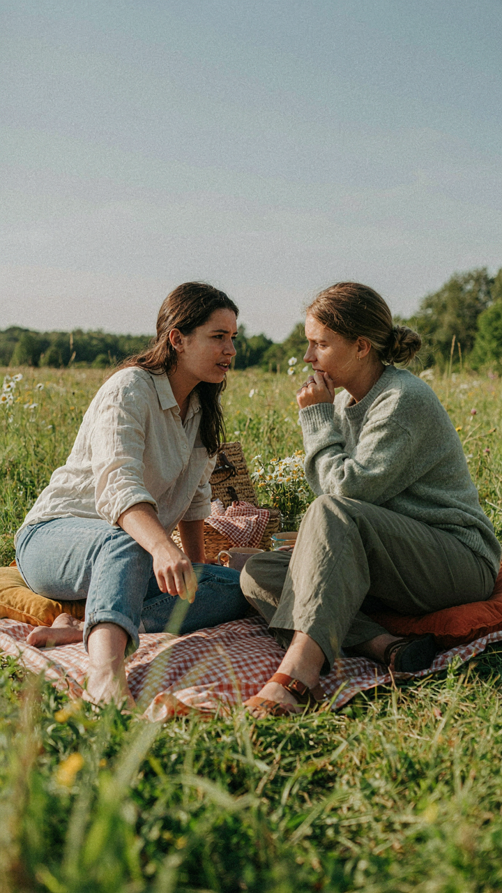 Two friends have a deep talk on floor cushions.