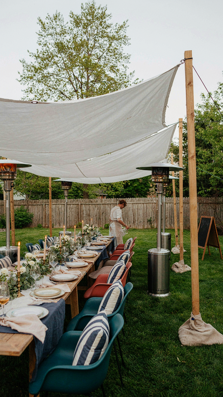 A resilient backyard party setup with overlapping canopies and heaters, ready for rain.