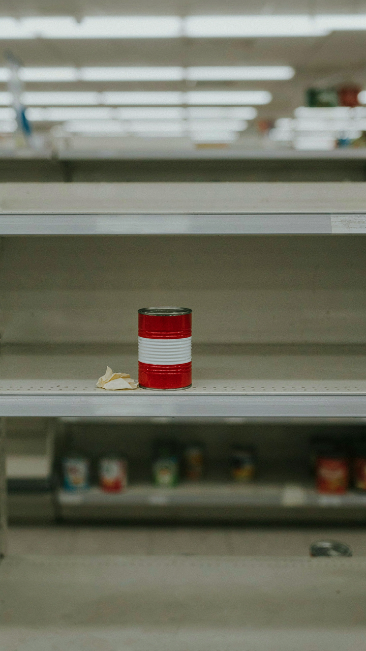 A single item sits on an otherwise empty grocery store shelf.