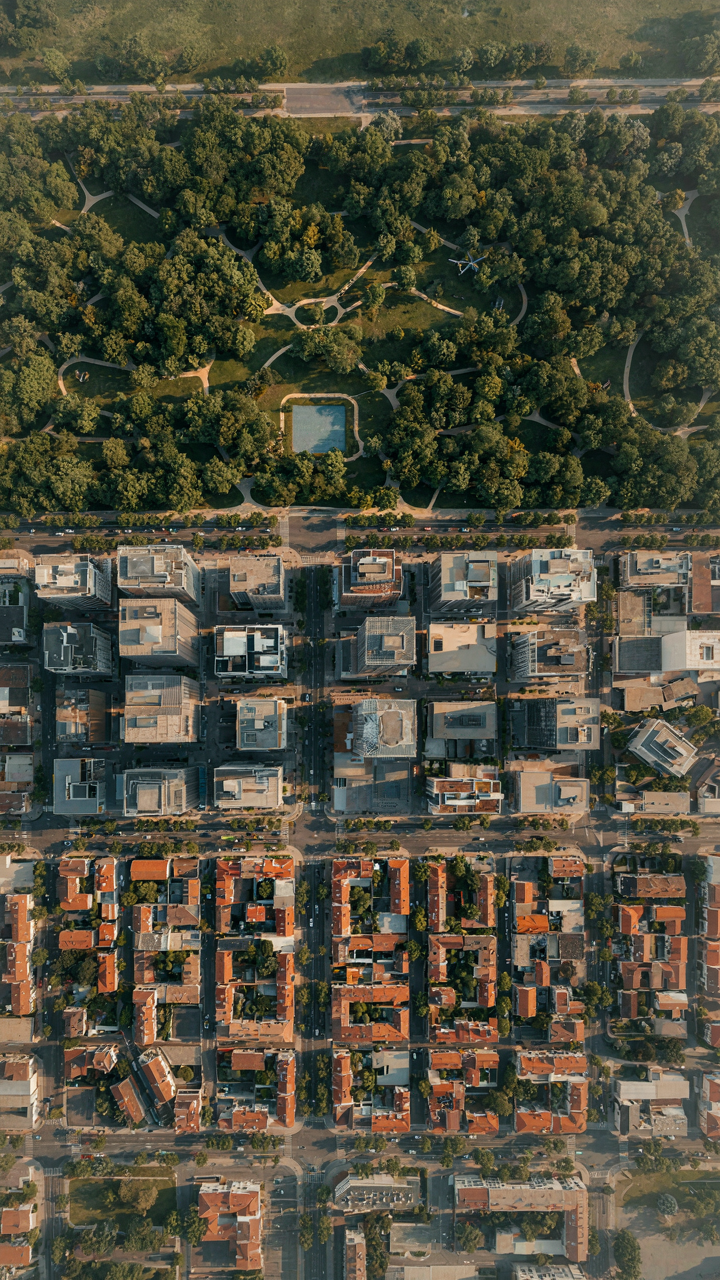 An aerial view of a city with distinct lighting in different zones.