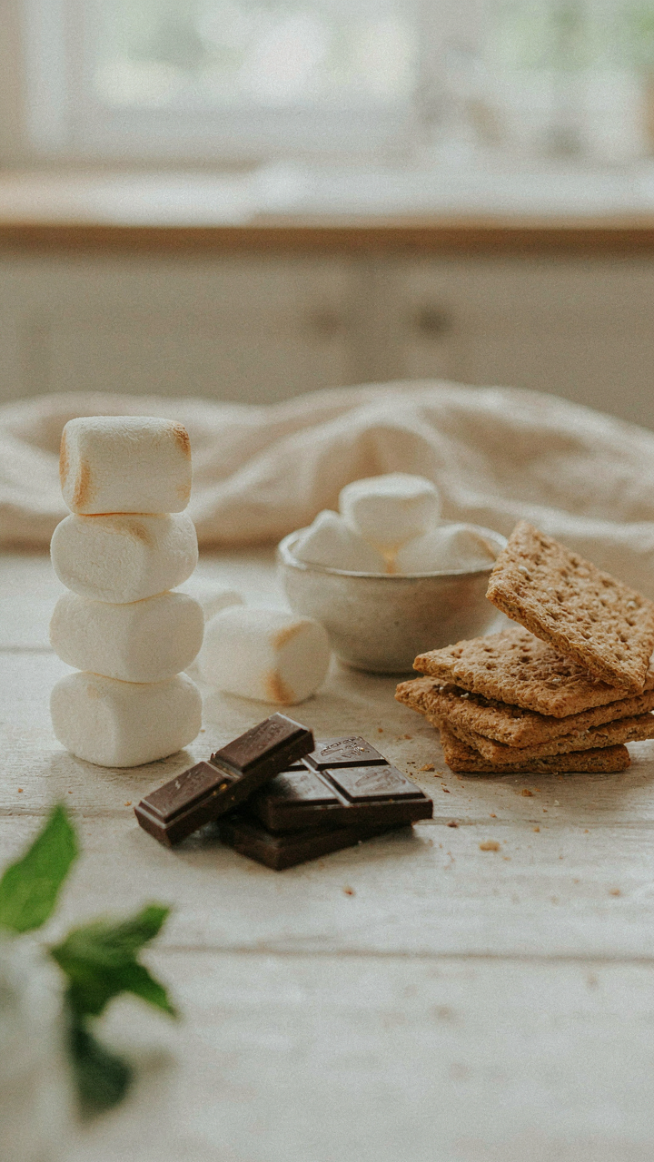 A s'mores bar with gourmet marshmallows, chocolate, and crackers.