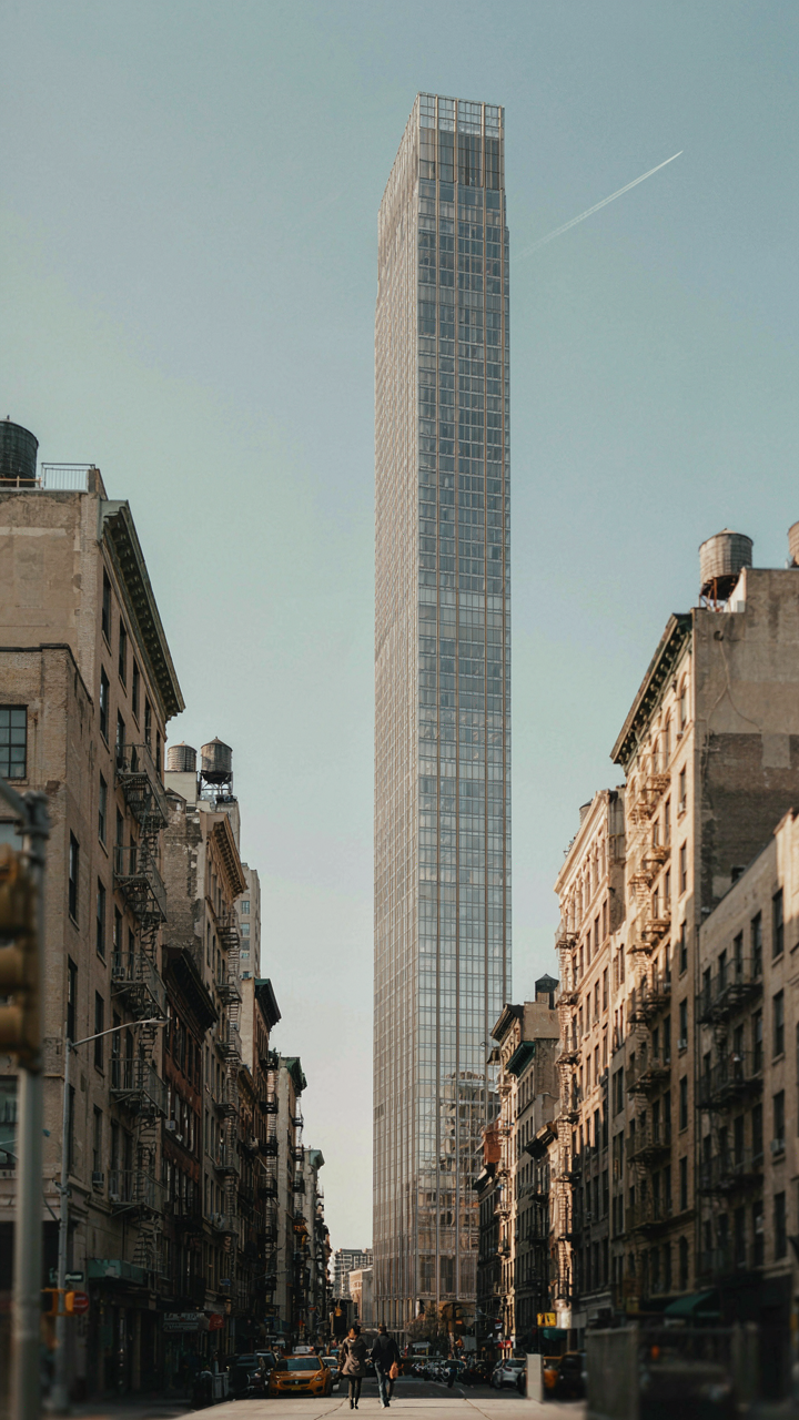 A small, well-designed skyscraper reaches high in a dense city.