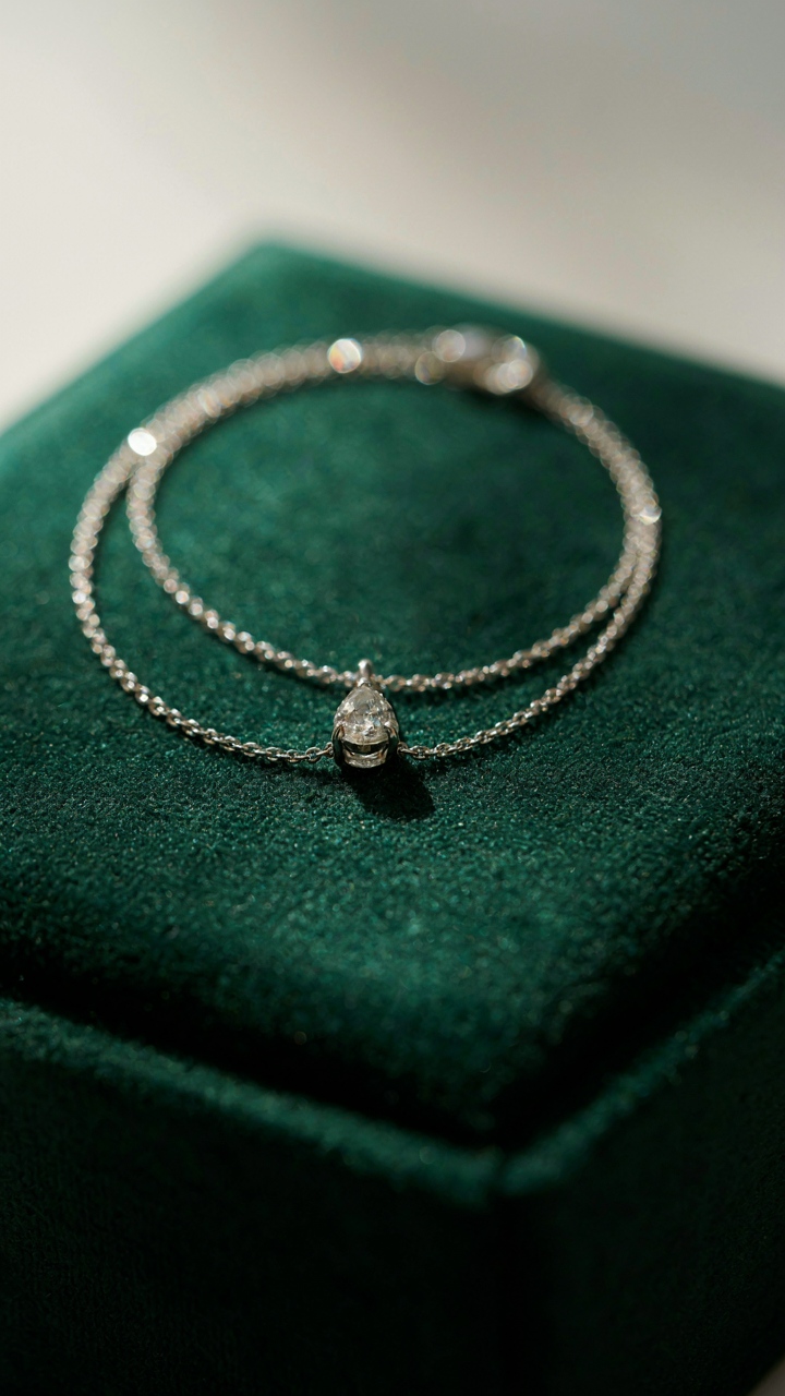A sparkling diamond necklace rests on a black velvet display.
