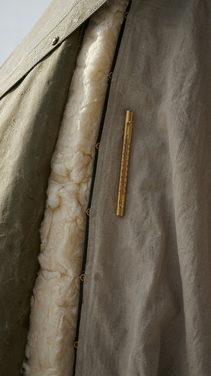 A cross-section of a canvas tent wall showing insulating layers to keep out cold.