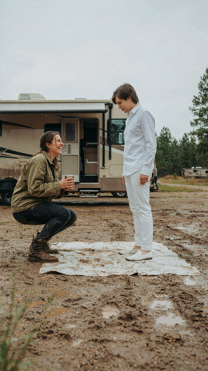 People with different mindsets at a muddy RV campsite, one relaxed, one rigid.