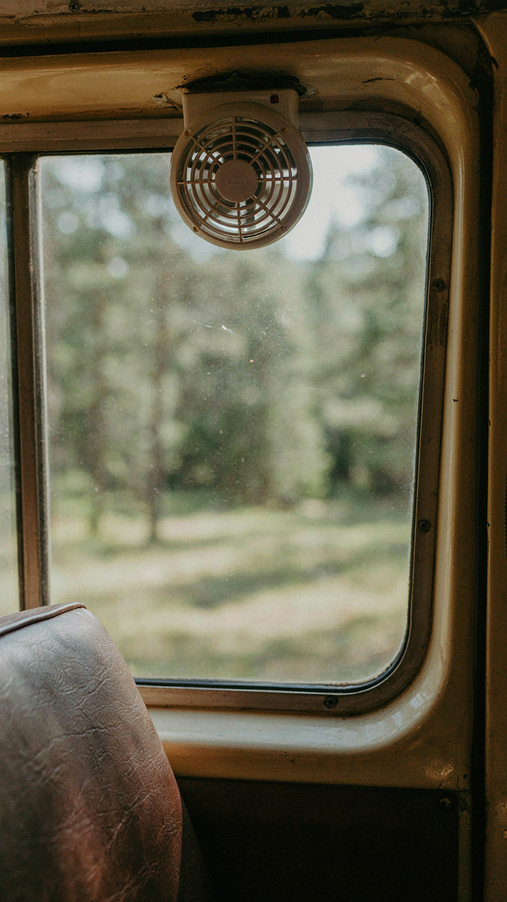 A small exhaust fan is visible in a camper van window.
