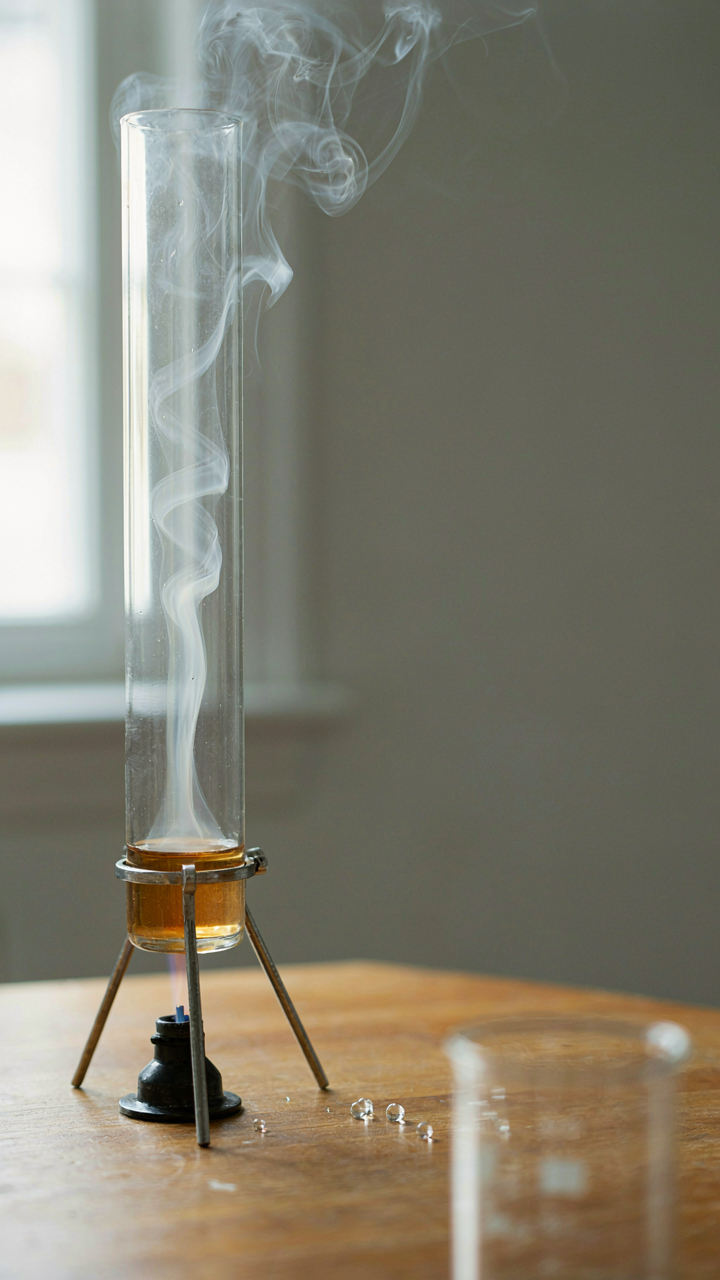 Smoke rises from a heat source in a clear container, showing air currents.