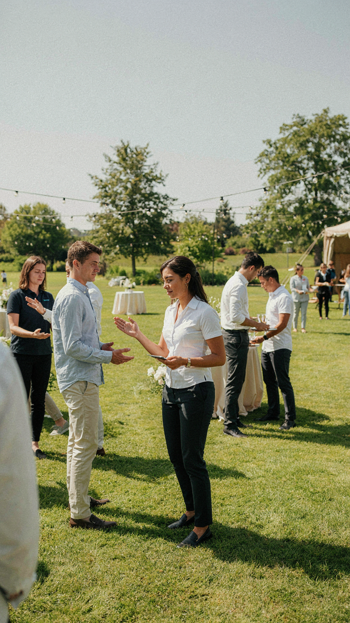 Event staff members are helping guests move through an outdoor event.