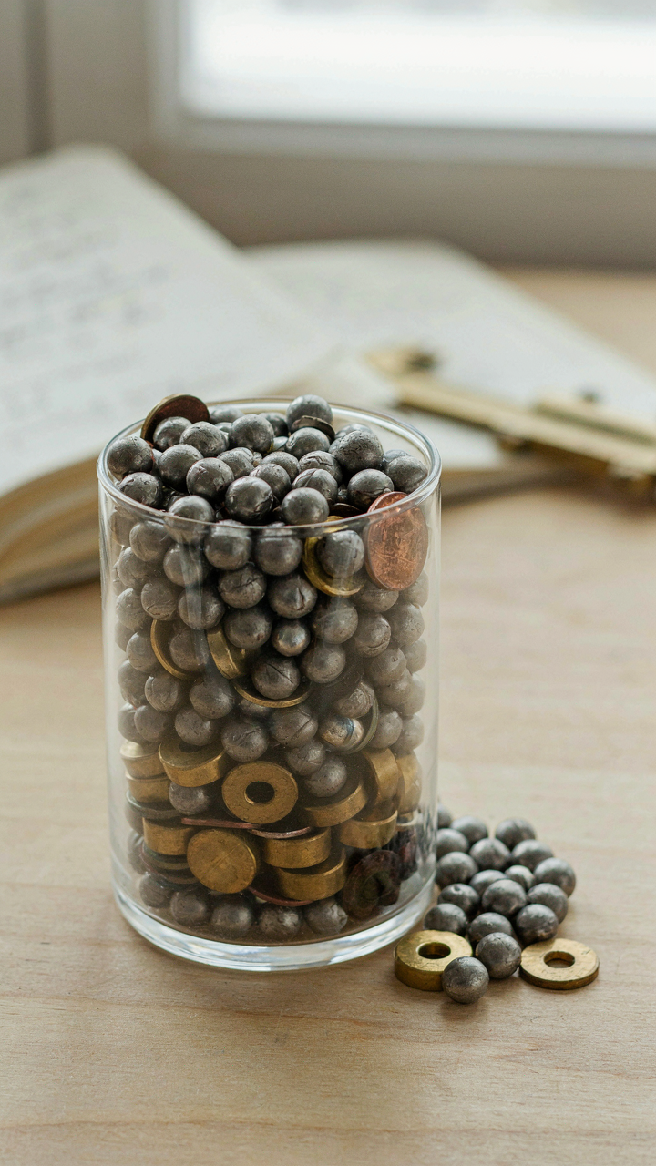 Heavy objects are packed tightly in a small clear box.