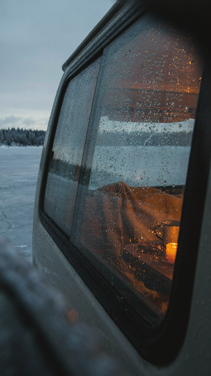Condensation covers a van window, showing cold air outside.